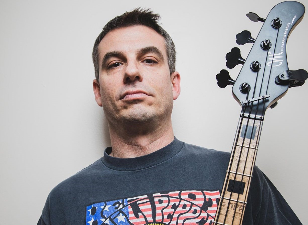 Phonic Pressure's bassist holding the neck of his bass