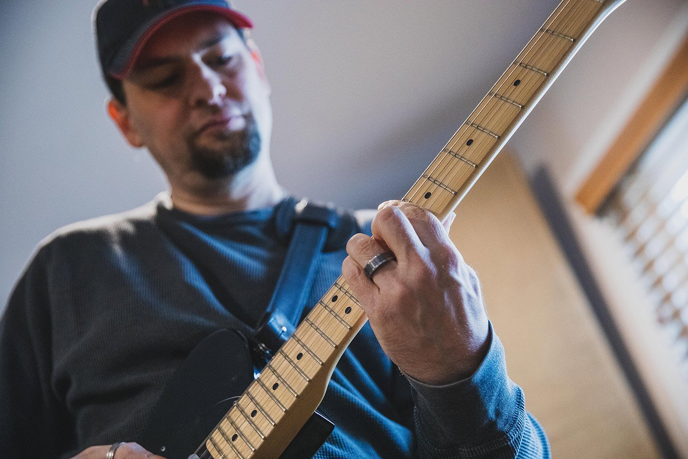 Phonic Pressure's guitarist playing an electric guitar